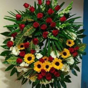 Corona fúnebre de girasoles y rosas